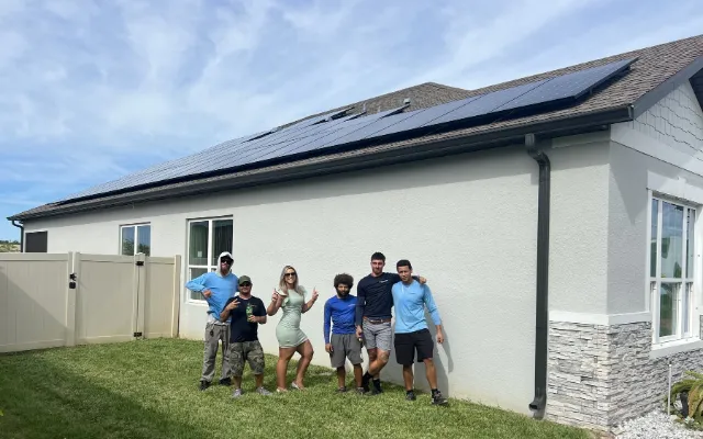 Homeowners in front of their solar home