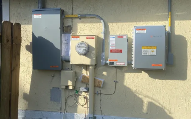Electric meter and service equipment beside a Florida home