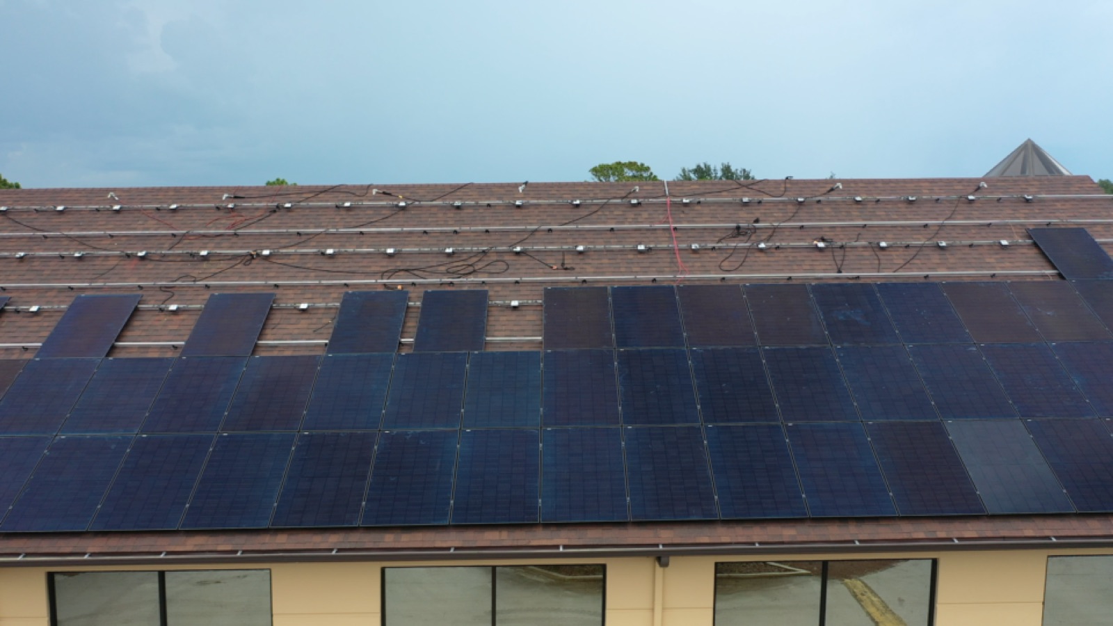All-black solar panels being installed on the first St. Luke's roof