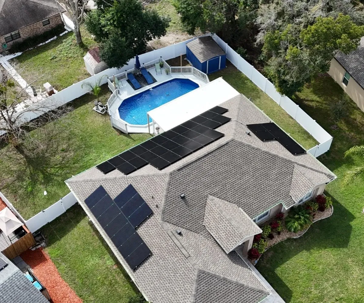 All-black solar panels installed on a Central Florida home beside a swimming pool