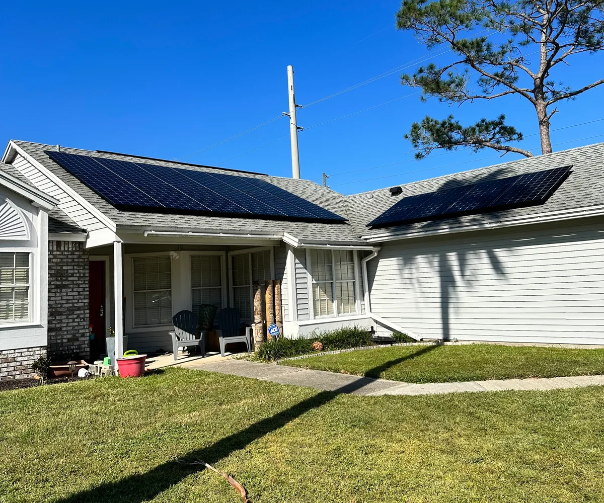 Street-level view of an all-black Sunstorm Energy rooftop solar installation