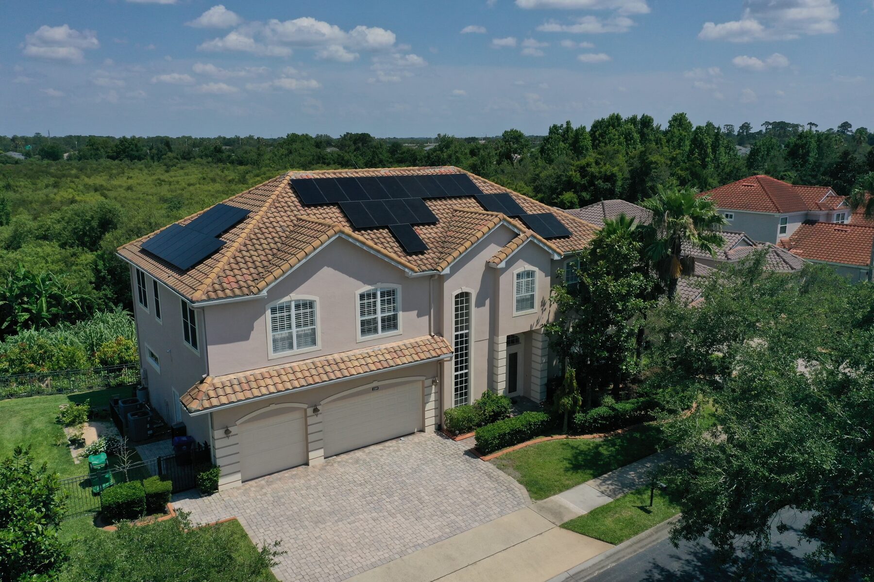 Aerial view of an all-black solar installation on a Central Florida tile-roof home