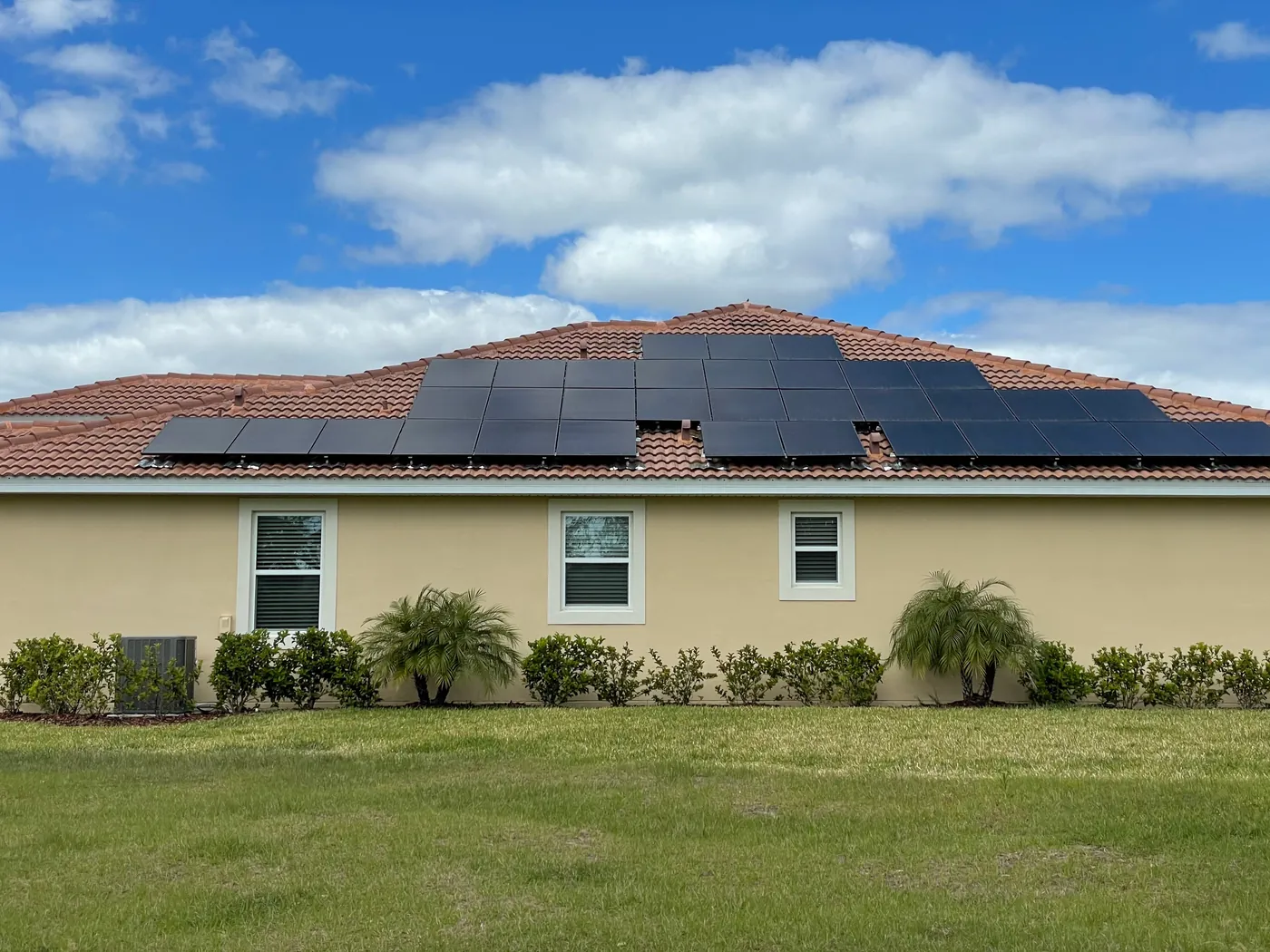 Wide view of an all-black solar installation on a tile roof