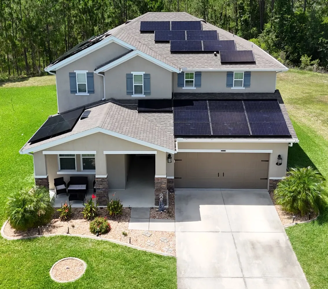 Front aerial view of an all-black Sunstorm Energy solar installation on a two-story home